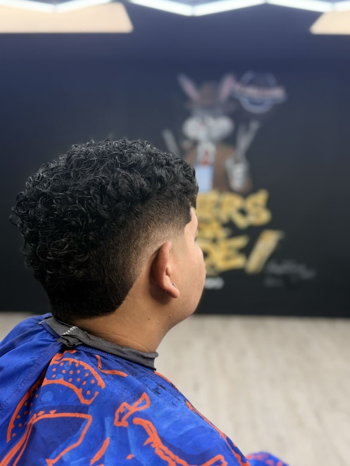 Curly fade with beard at Masters of da Fade